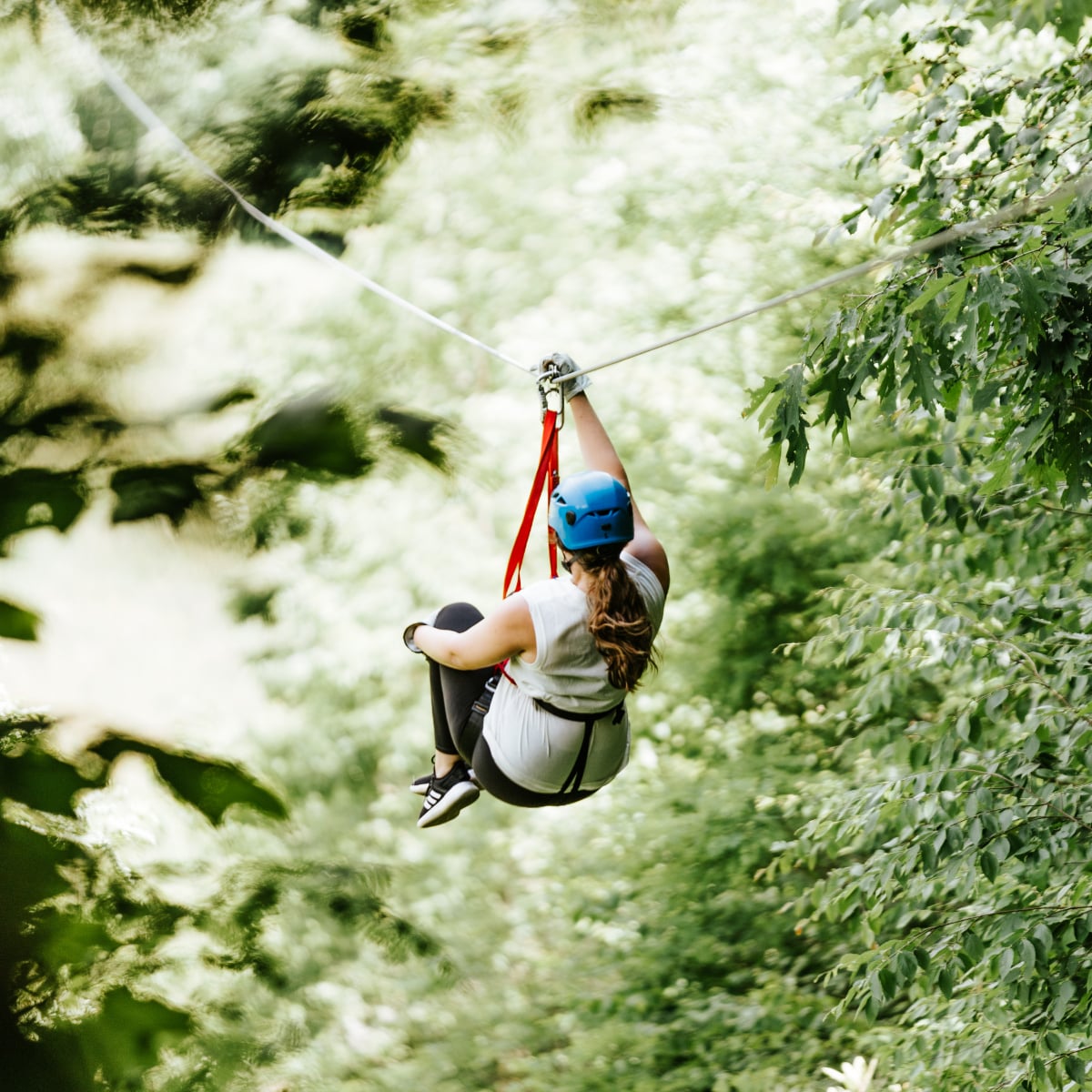 Two guests enjoying the full Hawksnest zipline experience